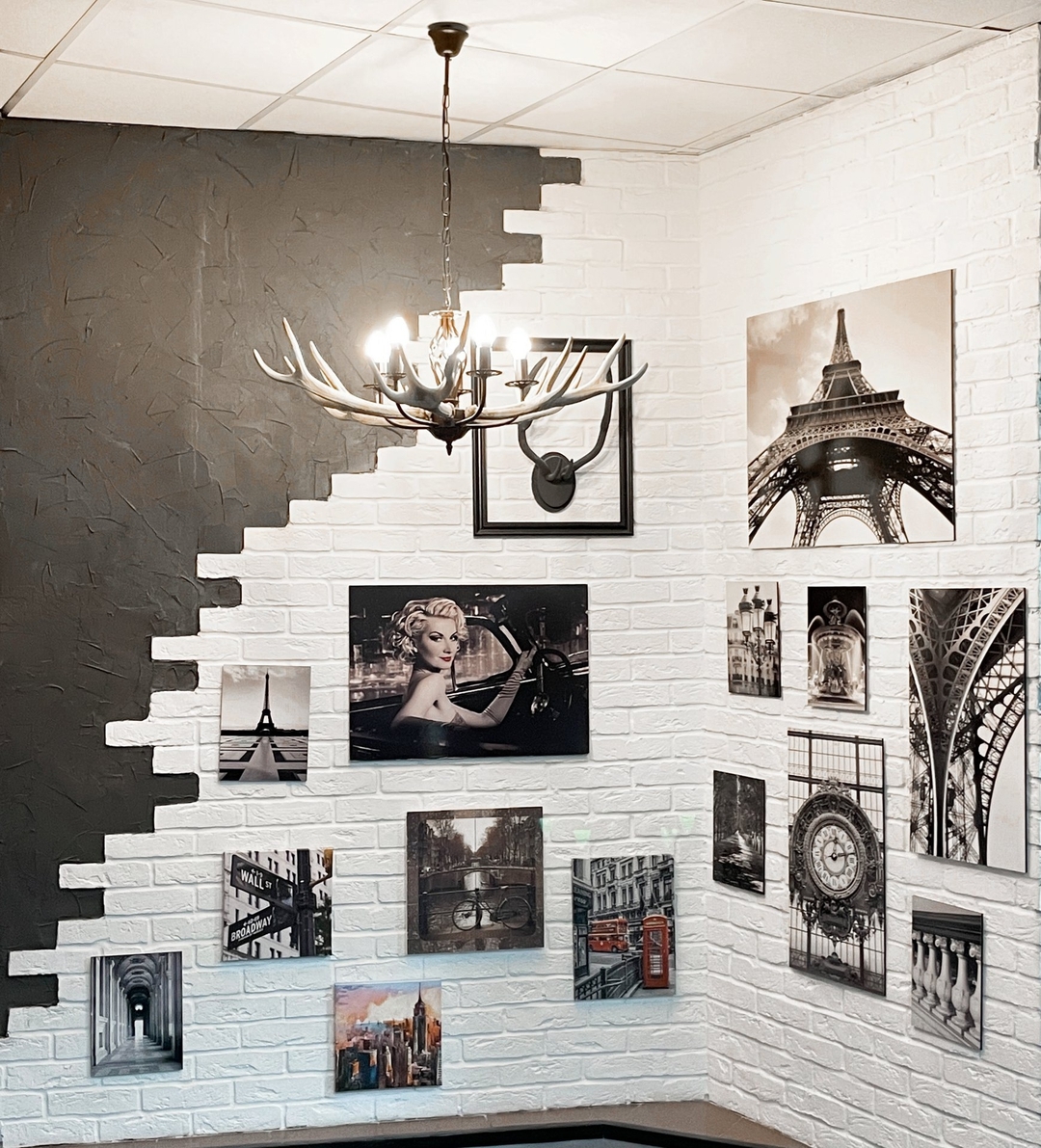 Hostel interior with framed photographs on white brick walls Hostel interior with framed photographs on white brick walls