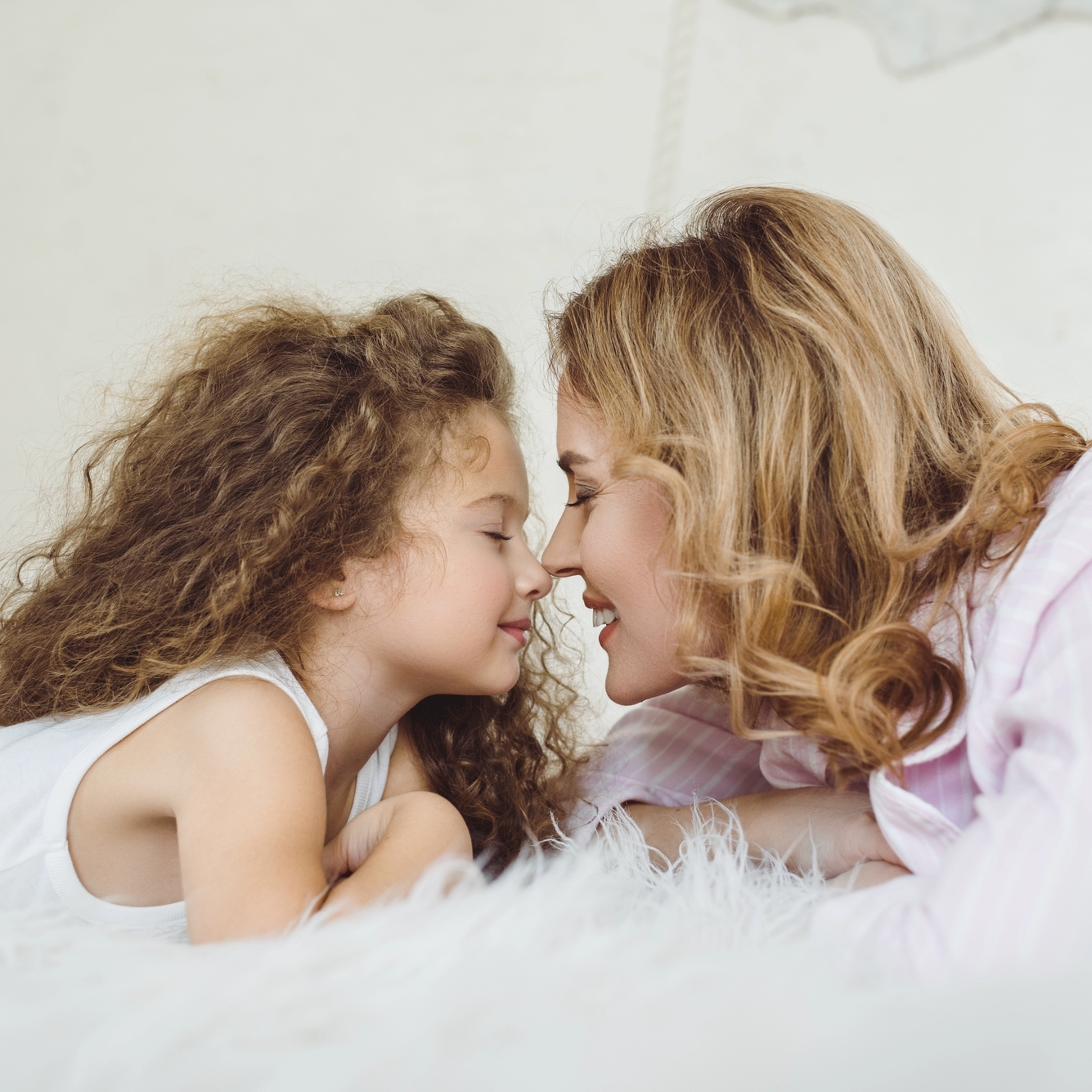 Mother and daughter lying face to face Mother and daughter lying face to face