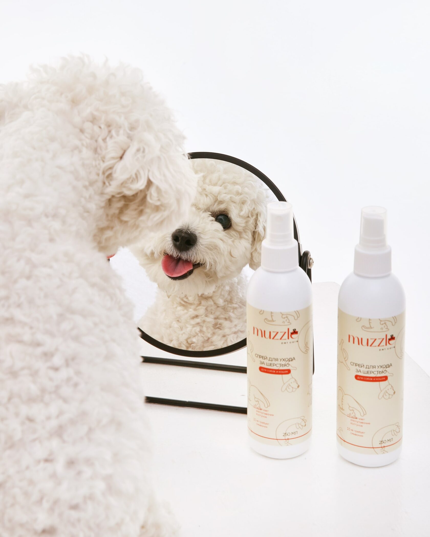 White dog beside a mirror and Muzzle pet care bottles White dog beside a mirror and Muzzle pet care bottles