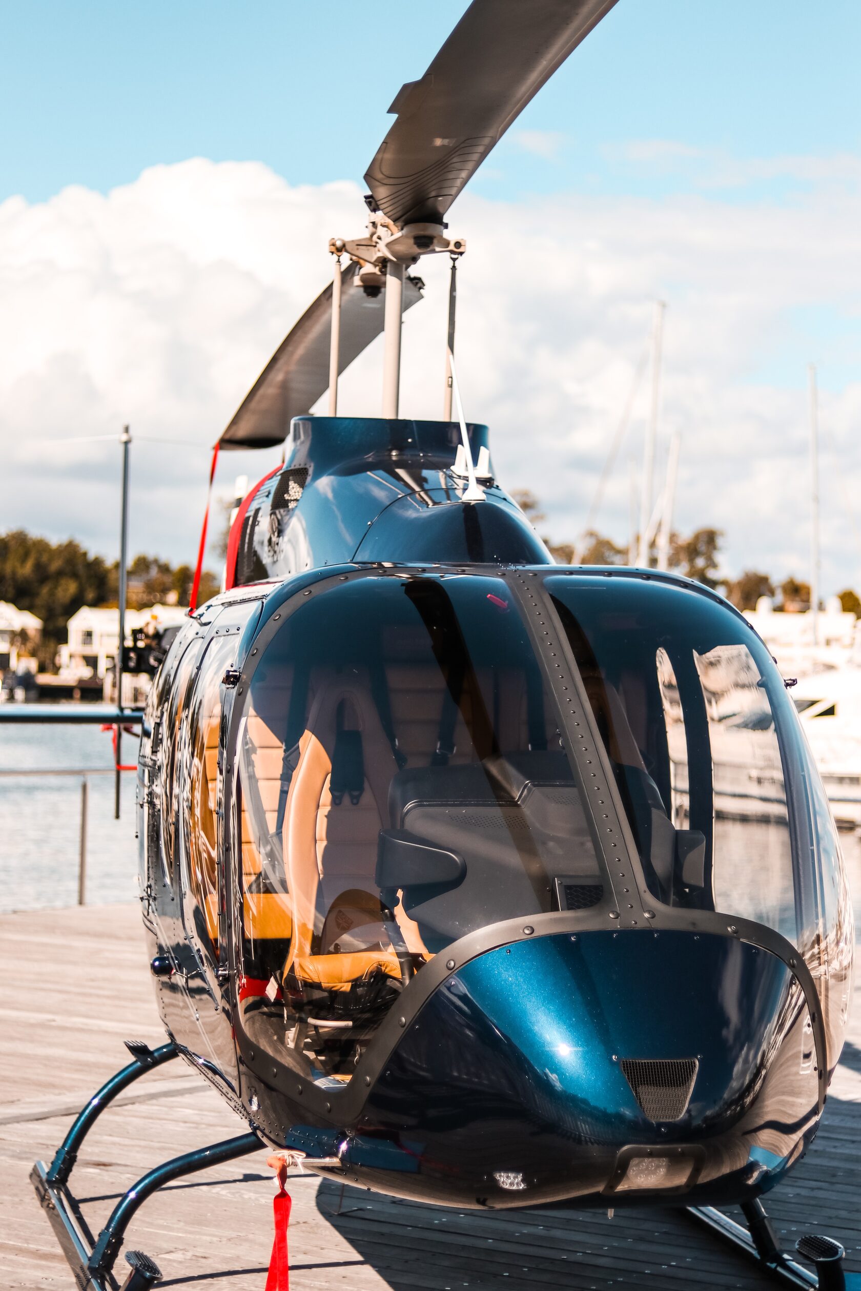 A blue helicopter on a landing pad A blue helicopter on a landing pad