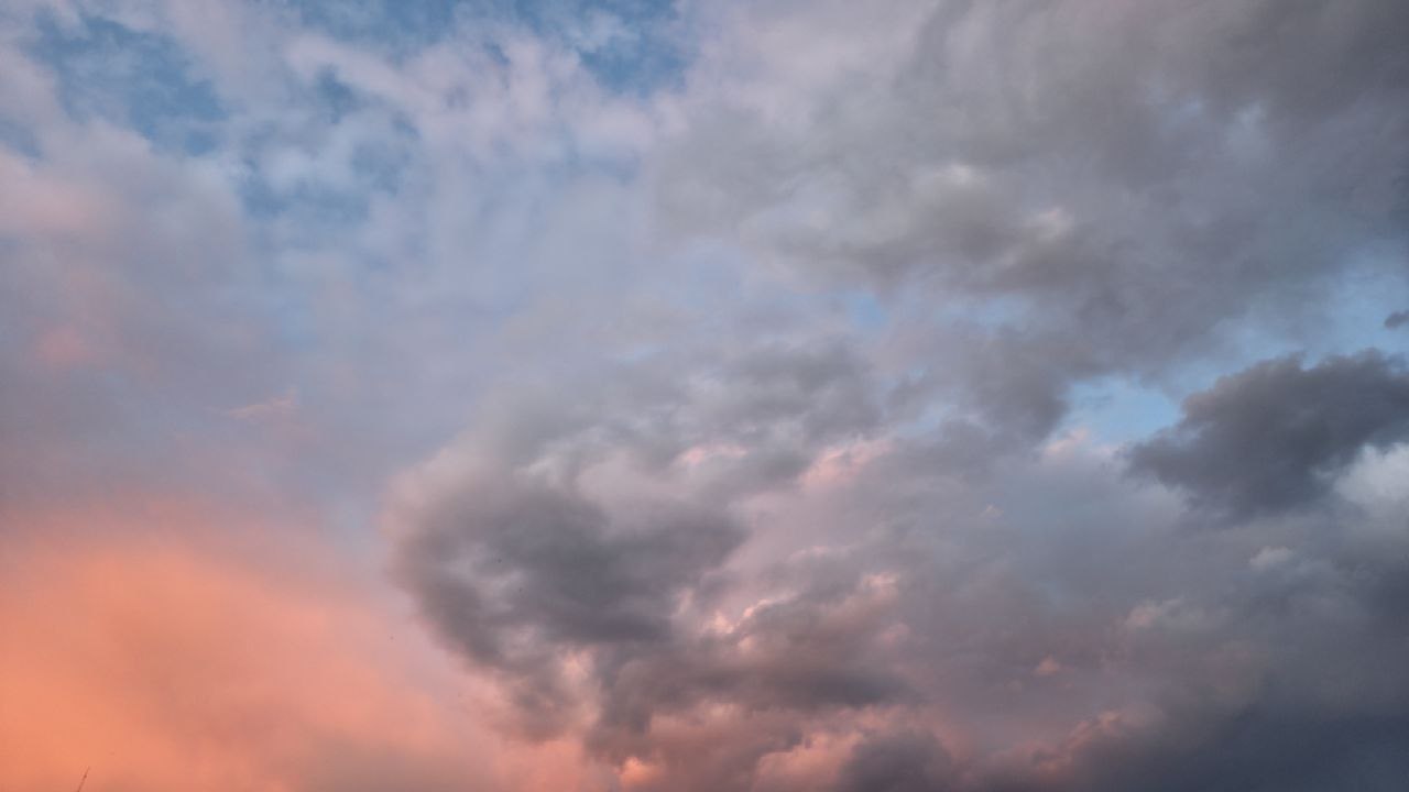 Clouds in an evening sky lit by a pink sunset Clouds in an evening sky lit by a pink sunset